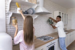 Organizing shelves and decor during a budget-friendly kitchen renovation.